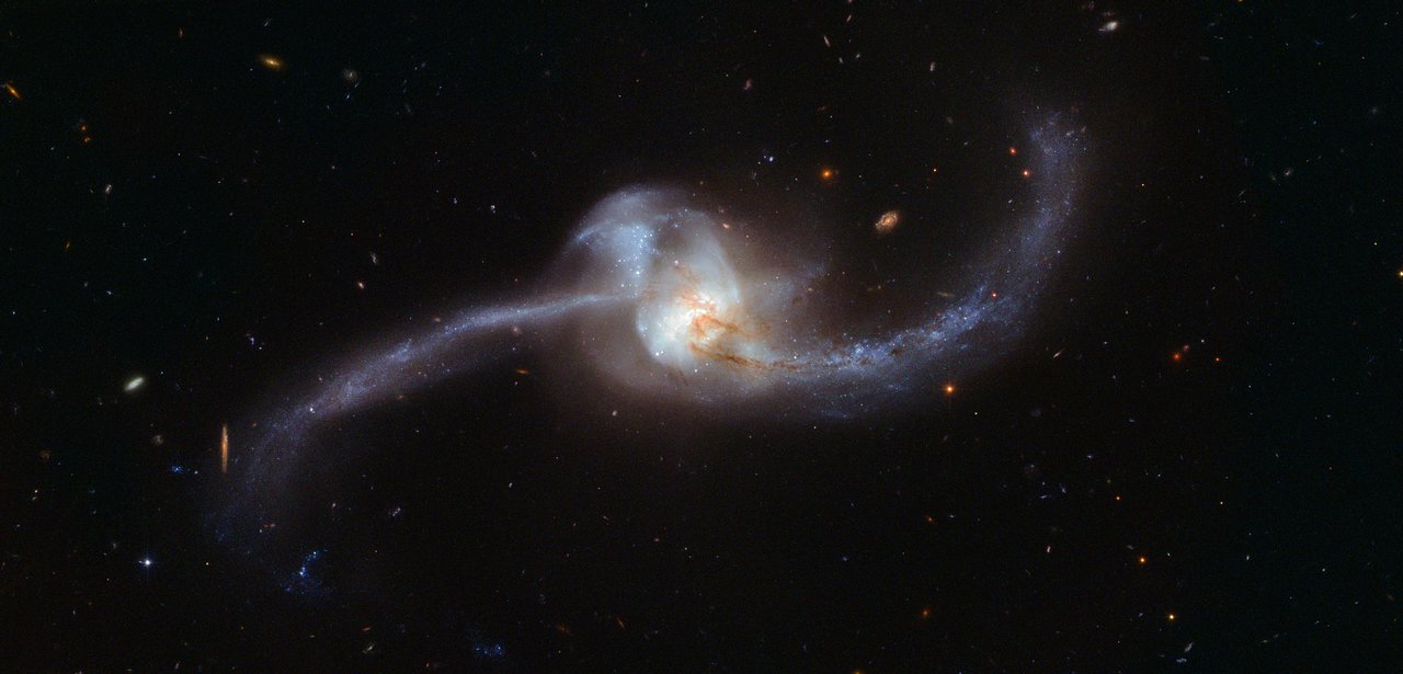 NGC 2623, a galaxy in the late stages of a merger with two tails emerging from the main body